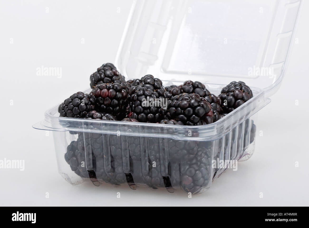 Blackberries fruit in plastic container selling at farmers market ...
