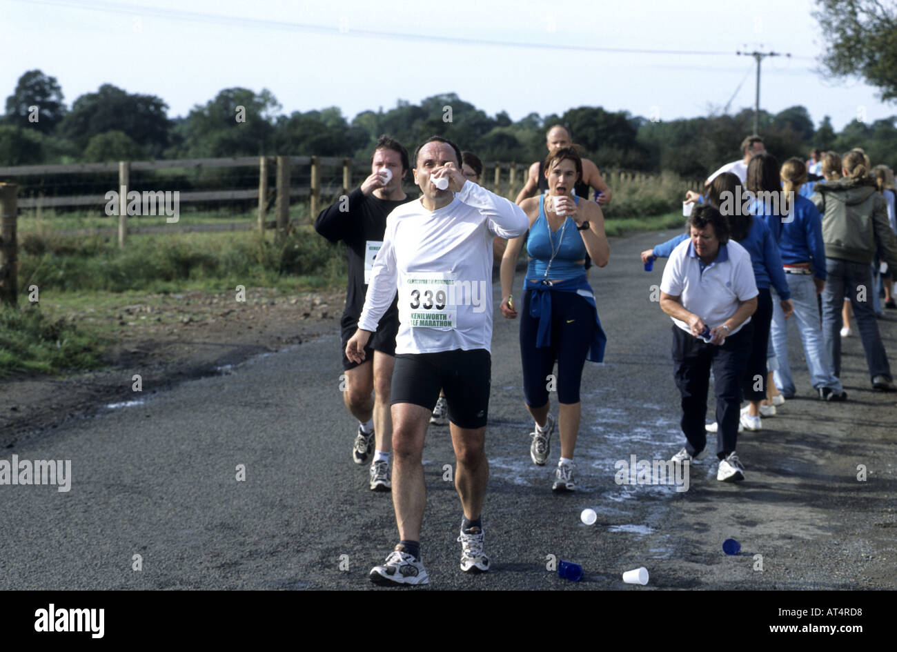 Runners drinking water during Kenilworth Half Marathon race