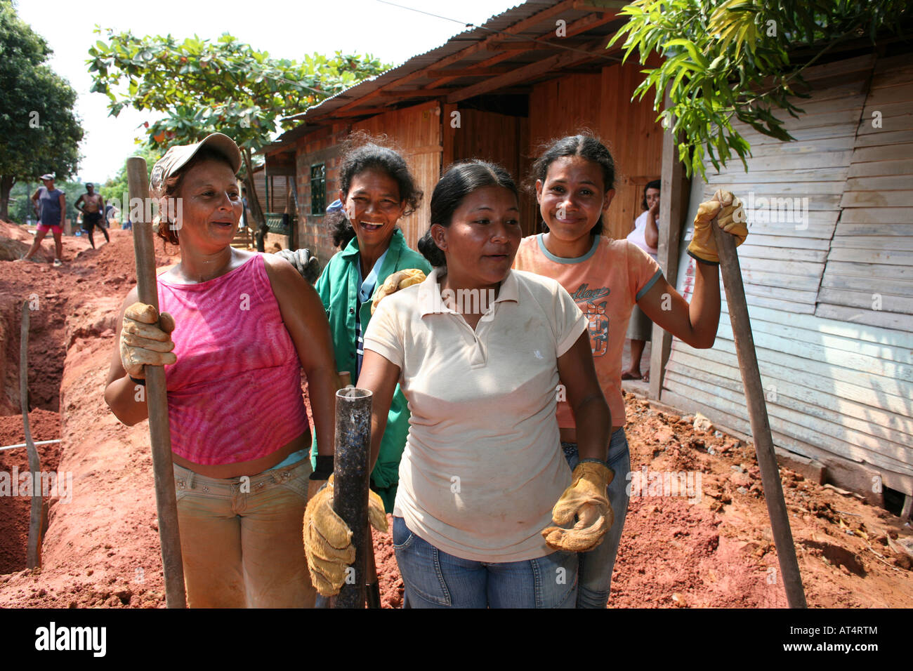 Poor communities building a sewerage system in their slum The government provides the materials Stock Photo