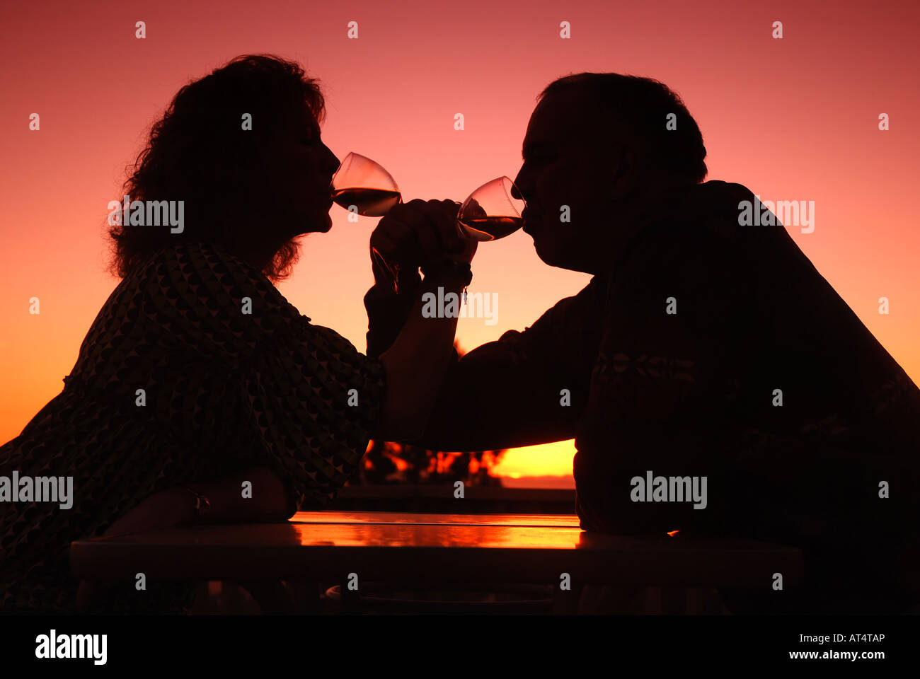Silhouette couple drinking wine sunset hi-res stock photography and ...