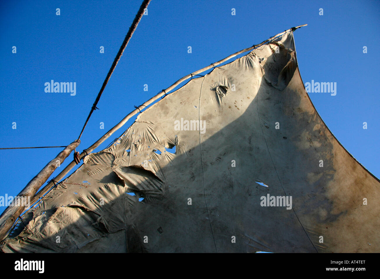 The triangular lateen sail of an outrigger canoe (ngalawa) off the