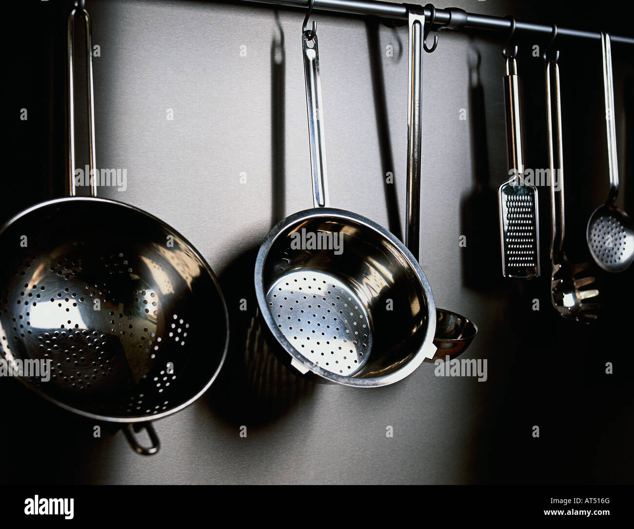 pots, pans and collinders, hanging up in a kitchen Stock Photo Alamy