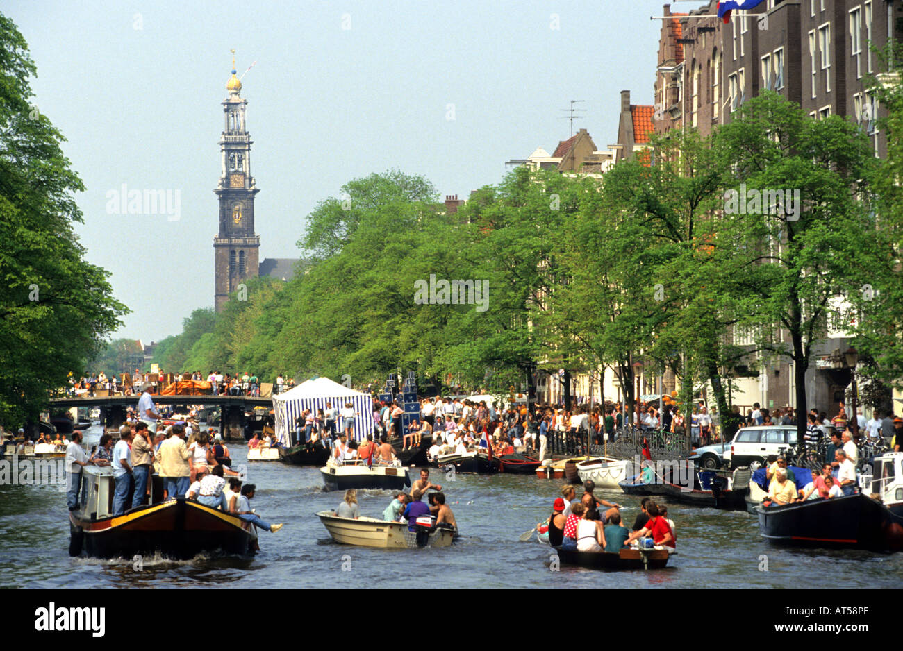 Netherlands Amsterdam Koninginnedag the Queen's  Queens party feast canal boat boats Stock Photo