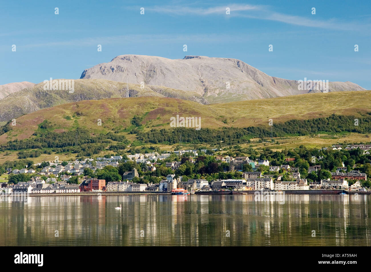 Ben Nevis, highest mountain in UK, rises above Fort William at the head of Loch Linnhe. Western Highlands, Scotland. Summer Stock Photo
