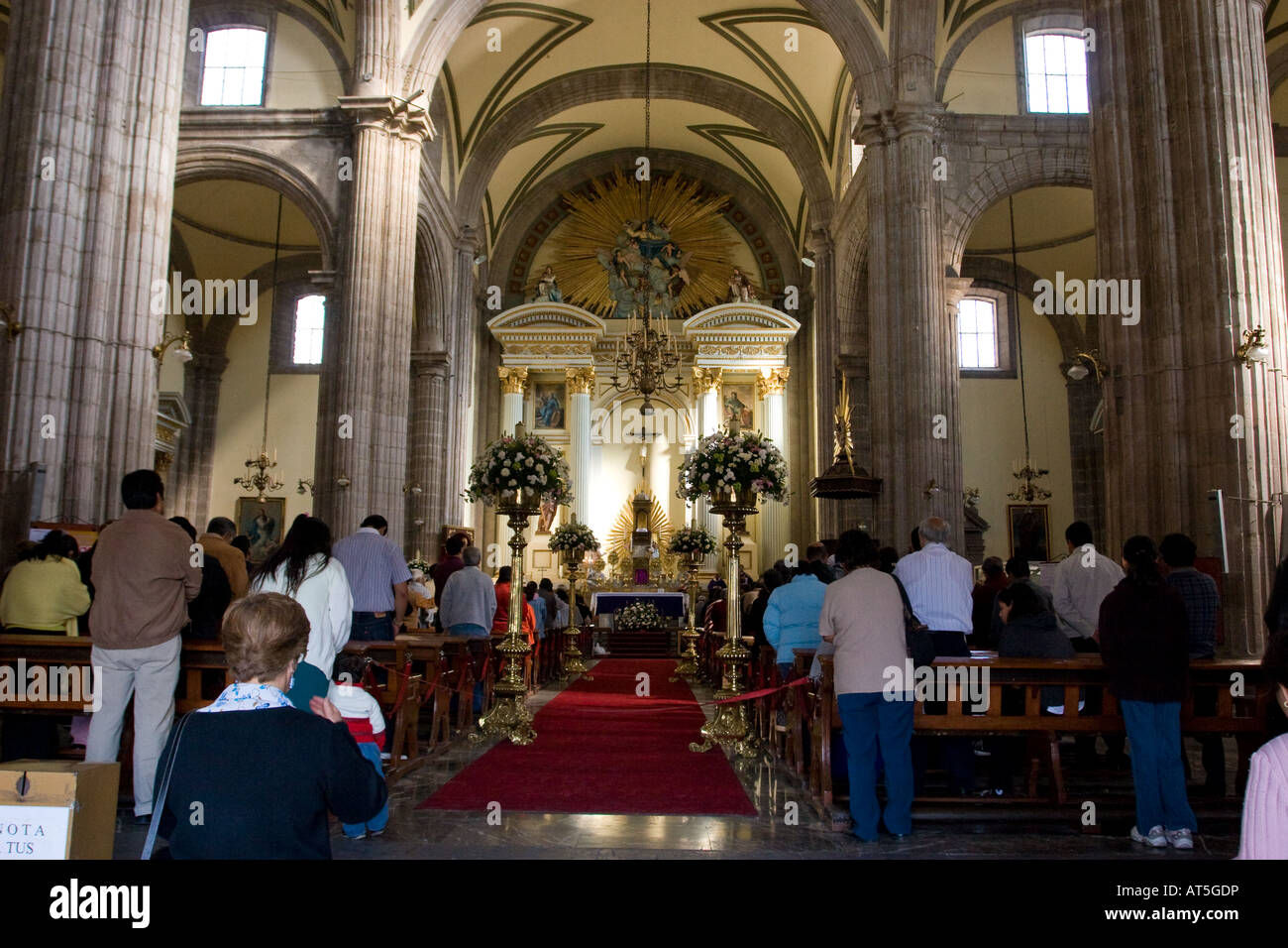 Interior of the Sagrario Metropolitano chapel, Metropolitan Cathedral, Mexico City DF, Mexico during a baptism ceremony Stock Photo