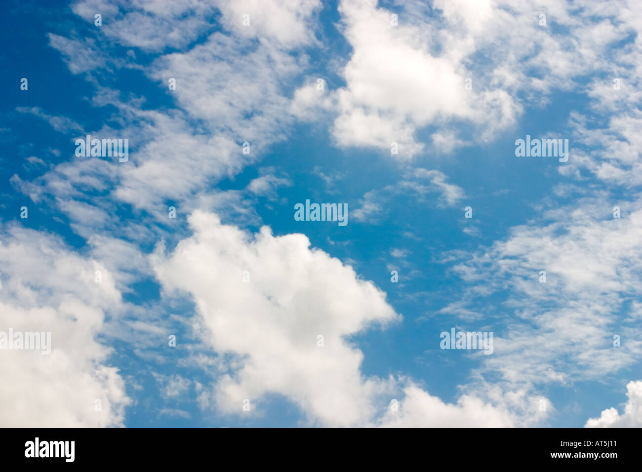 Blue sky with drifting white fluffy clouds Stock Photo - Alamy