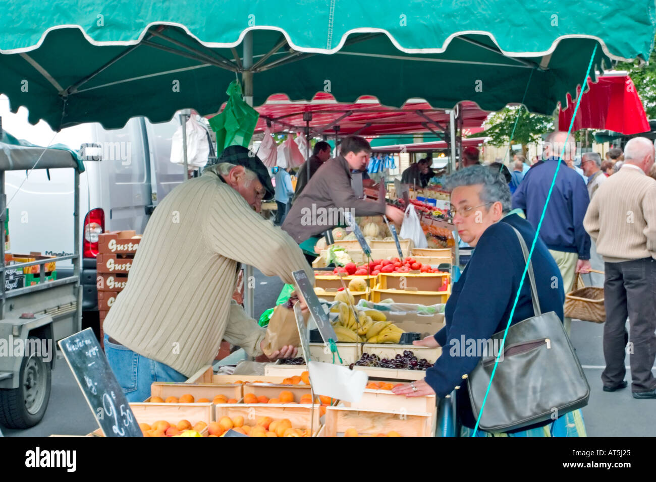 Shopping for fresh fruit and vegetables stall at street market in Bayeux France Stock Photo