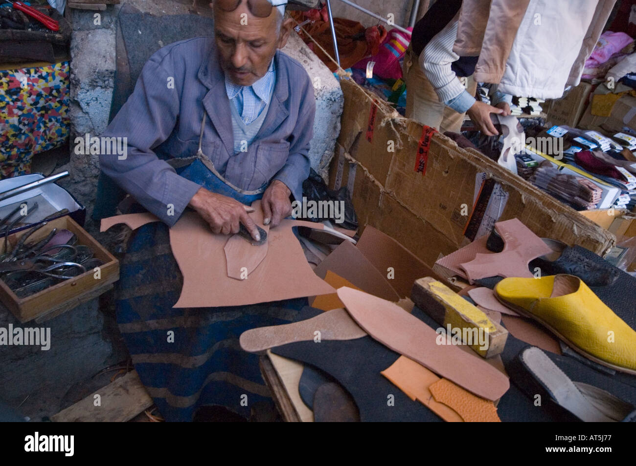 Morocco shoemaker works on leather in souk Marrakech Stock Photo