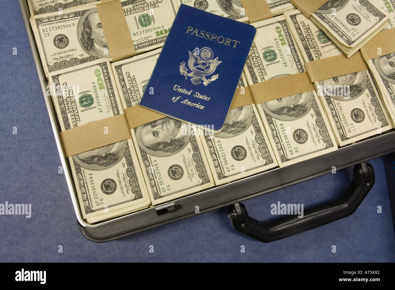 briefcase full of 100 dollar bills US and passport Stock Photo 5291905