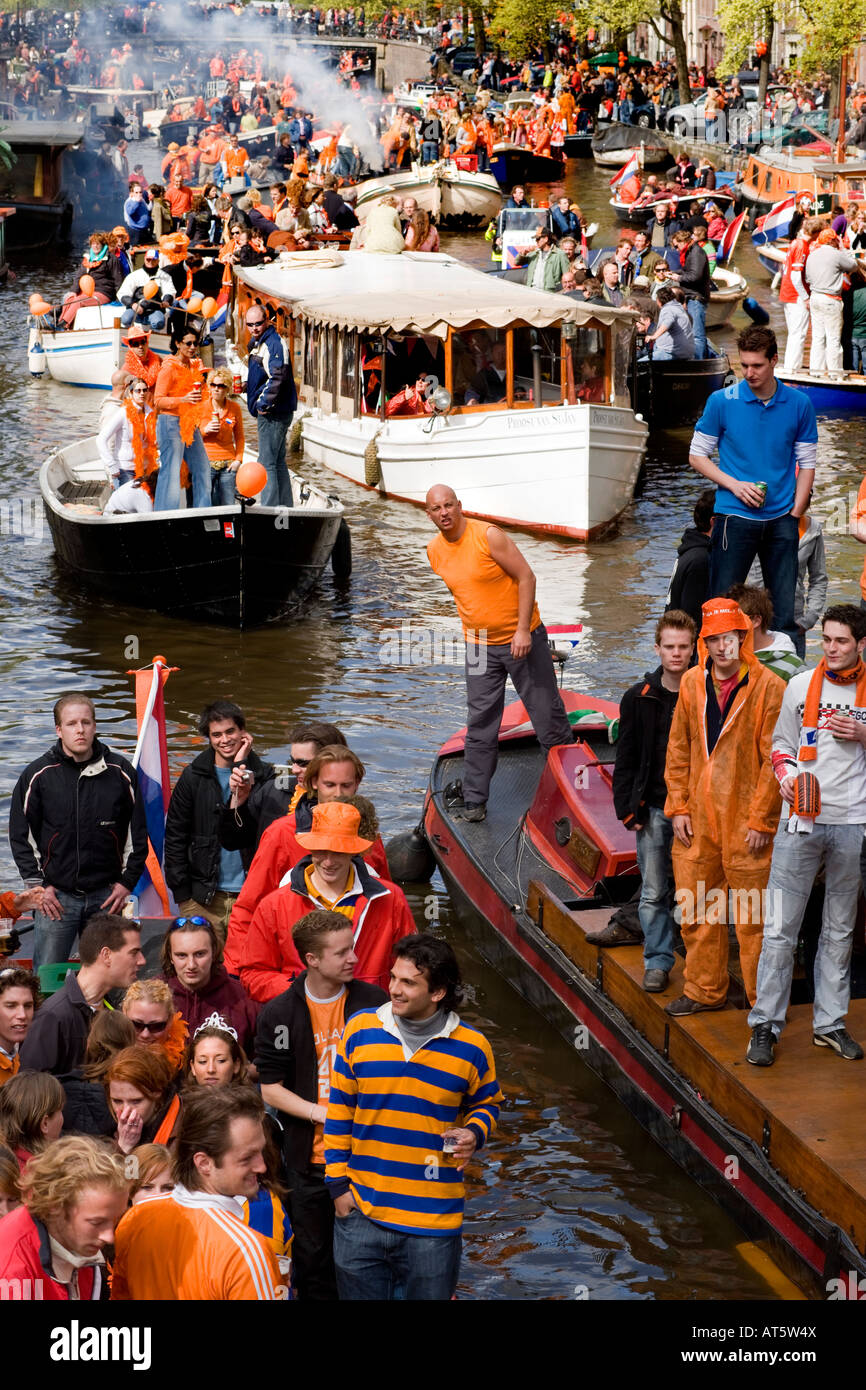 Traditionally all of Amsterdam is colored orange on the Queen's birthday. Water traffic jam on the Prinsengracht canal. Stock Photo