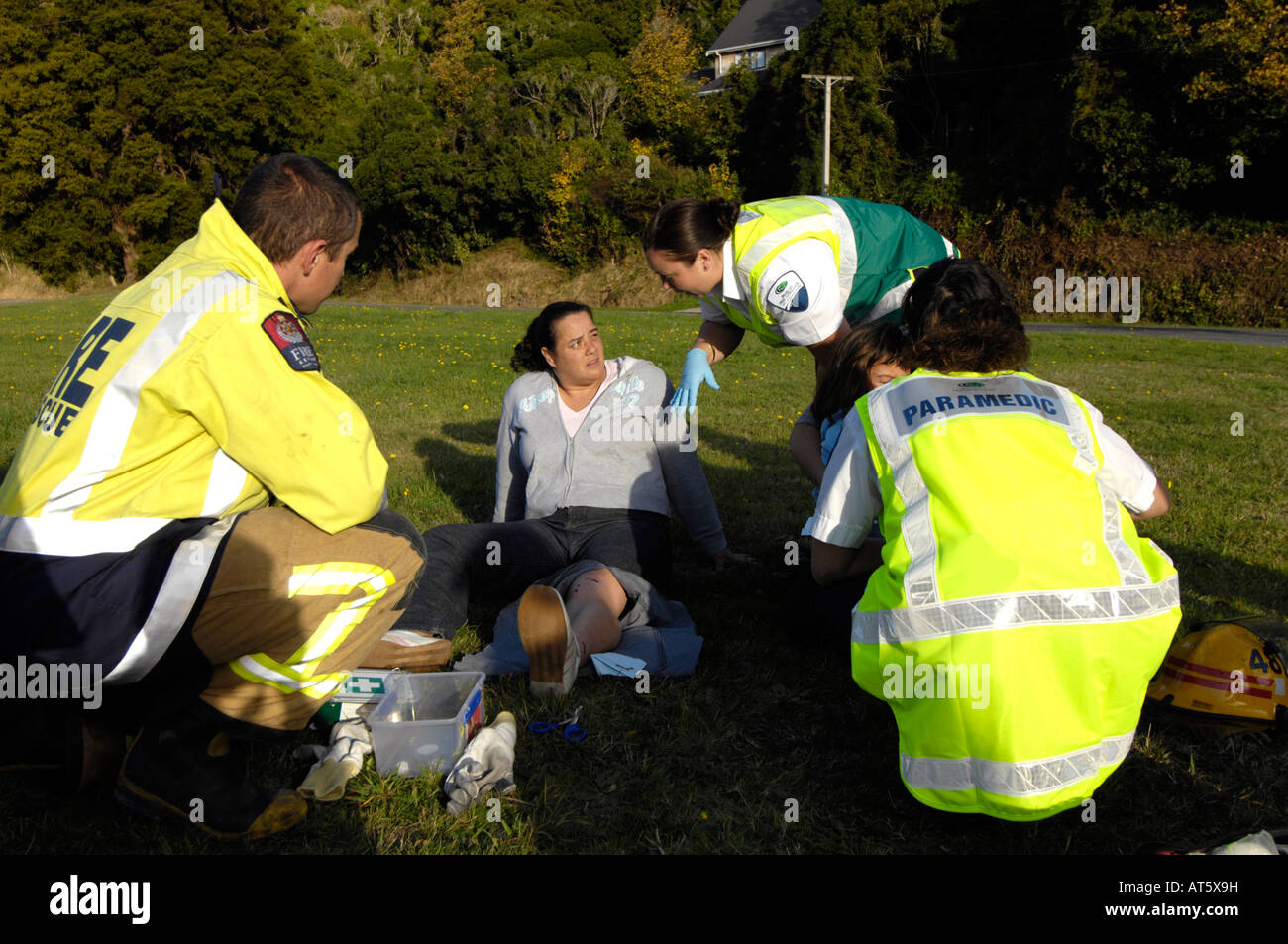 Paramedics and police tend to a victim injured in a car accident, Wellington, New Zealand Stock Photo