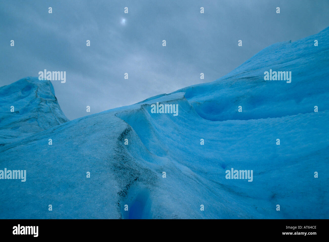Ice valleys on the windswept white surface of the Perito Moreno Glacier
