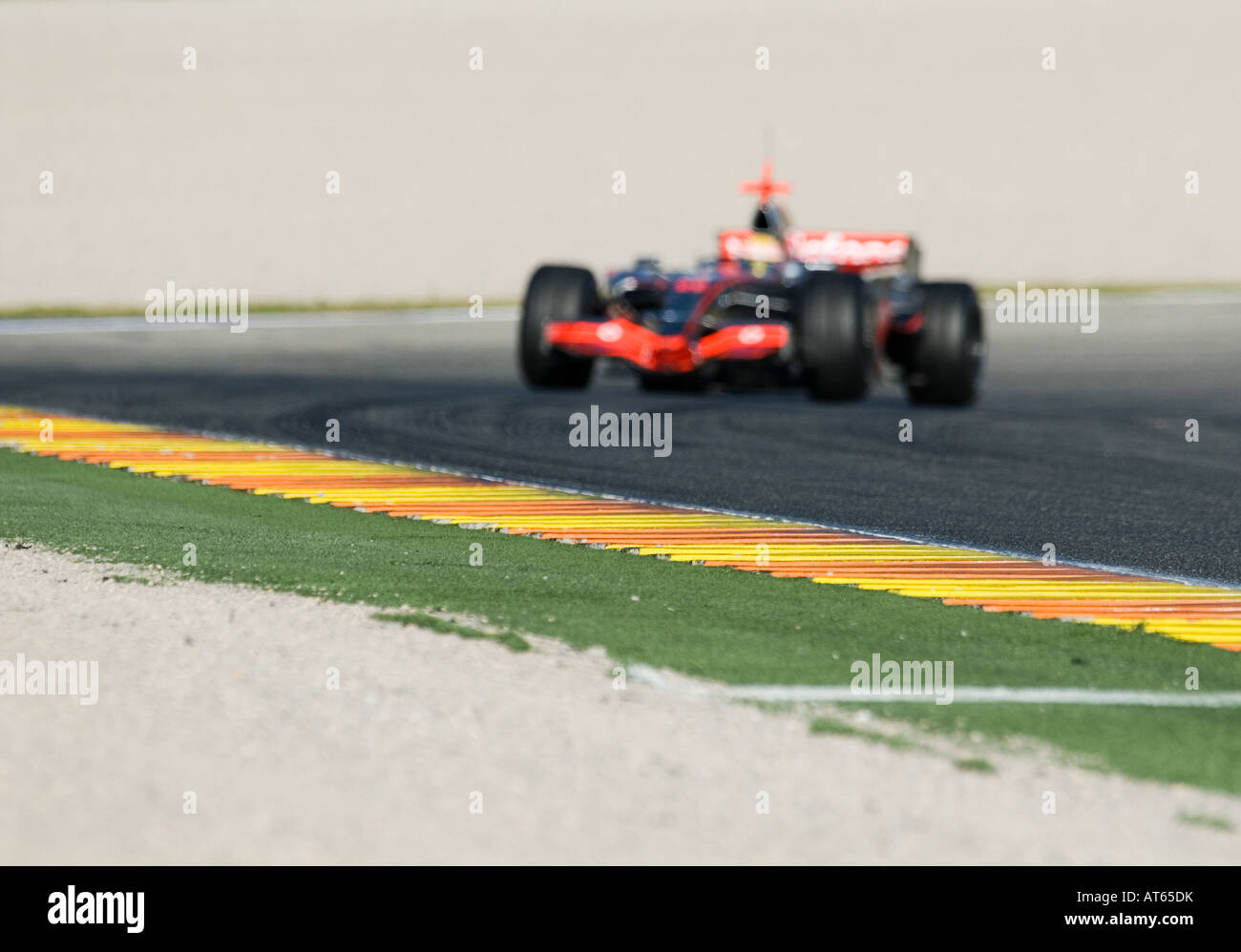 McLaren Formula 1 racecar speeds through curve of racetrack INTENTIONAL ...