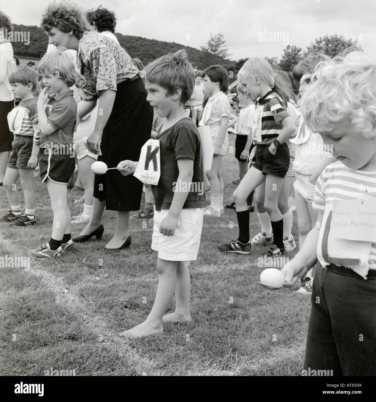 Young primary school children boy 5 yrs determination getting ready for the egg and spoon race on school sports day in Llanwrda Wales UK  KATHY DEWITT Stock Photo