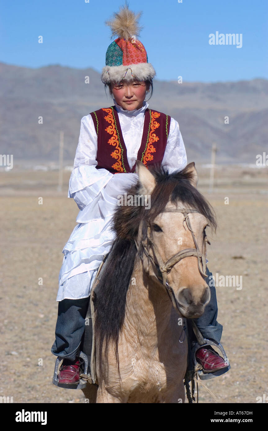 A Young Kazakh Girl In Traditional Dress Riding A Horse At The Annual a-young-kazakh-girl-in-traditional-dress-riding-a-horse-at-the-annual