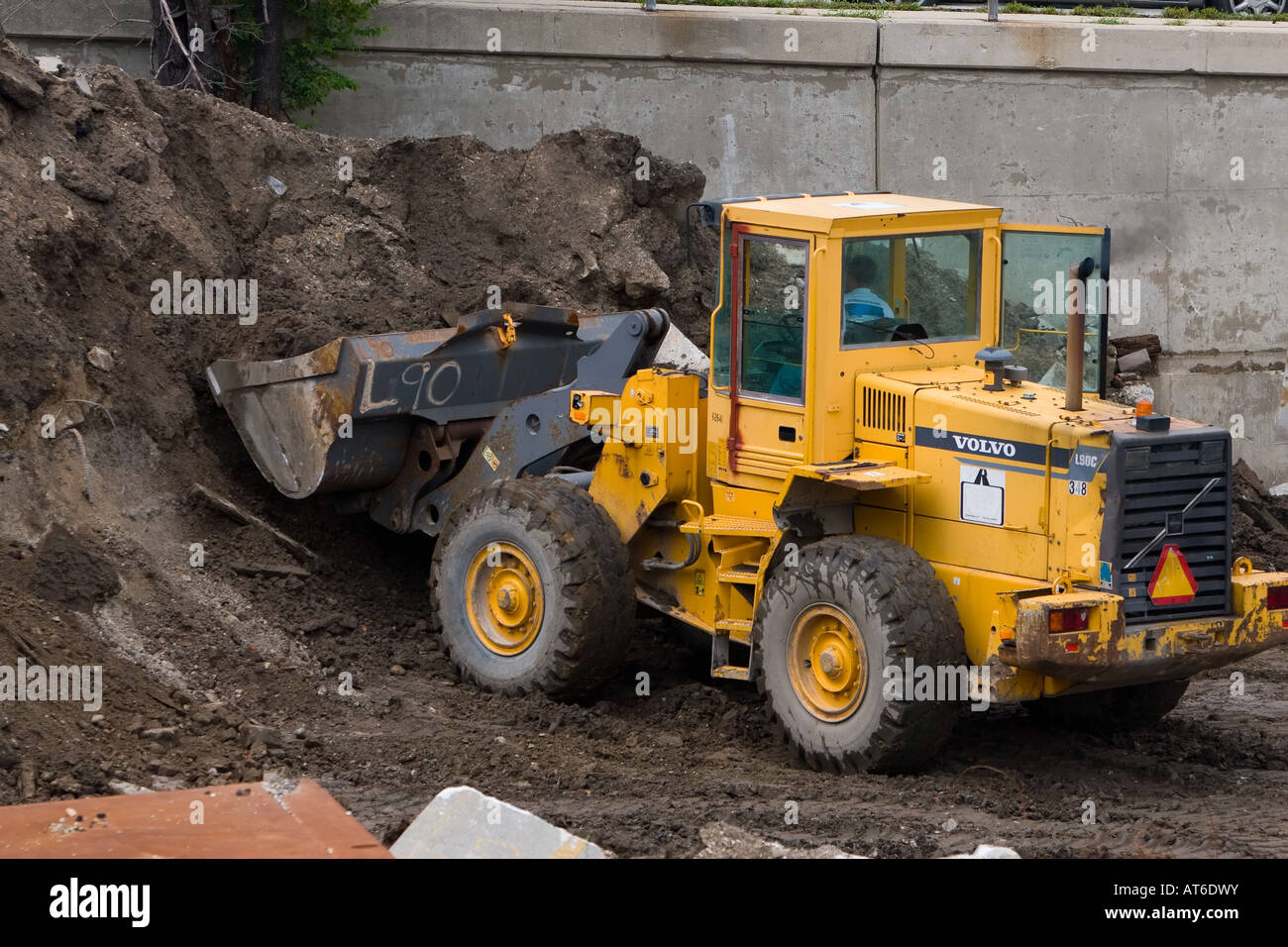 A front end loader works a pile of dirt at a construction site on the south side of Chicago. Stock Photo