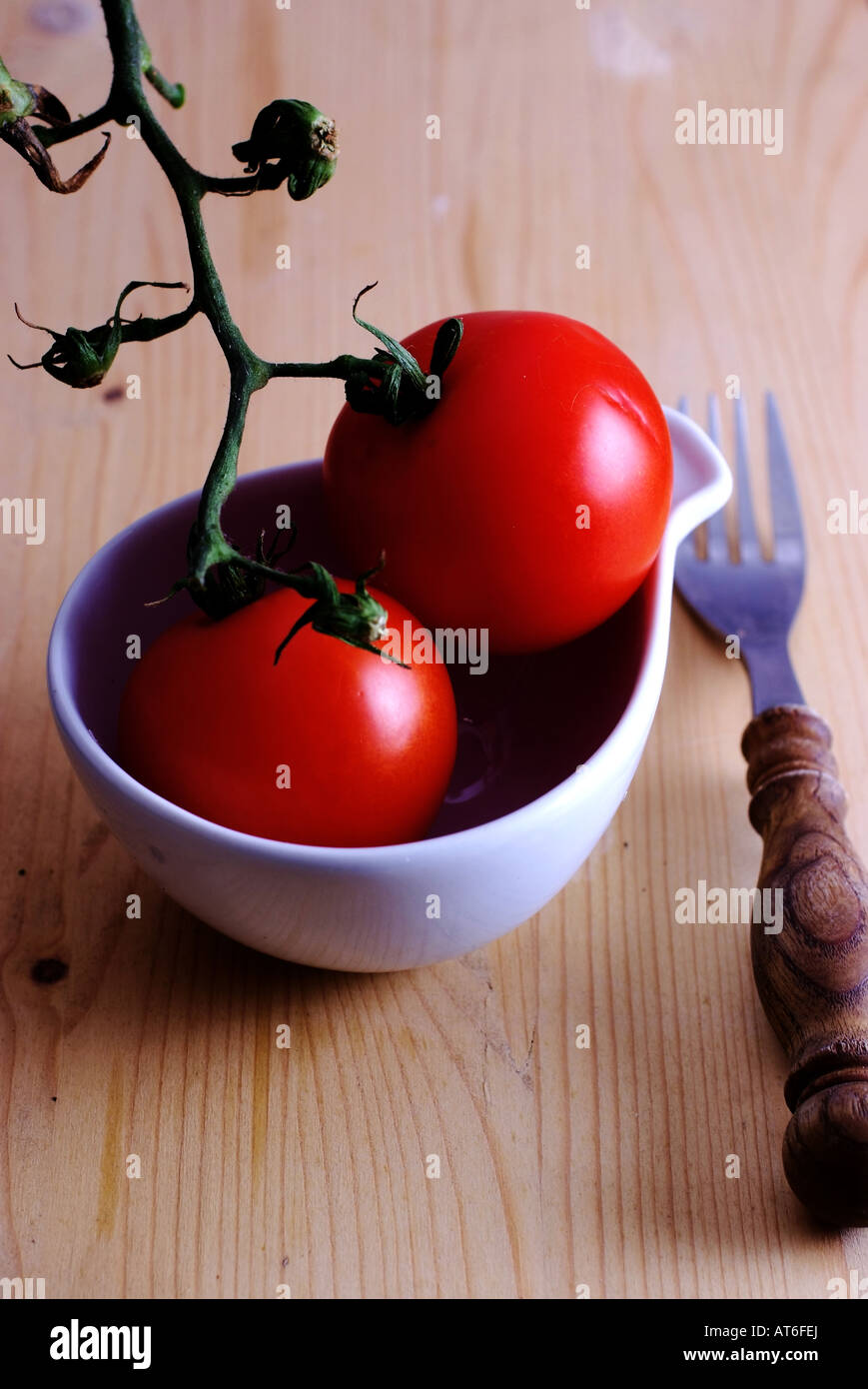 Red tomatoes in a cup Stock Photo