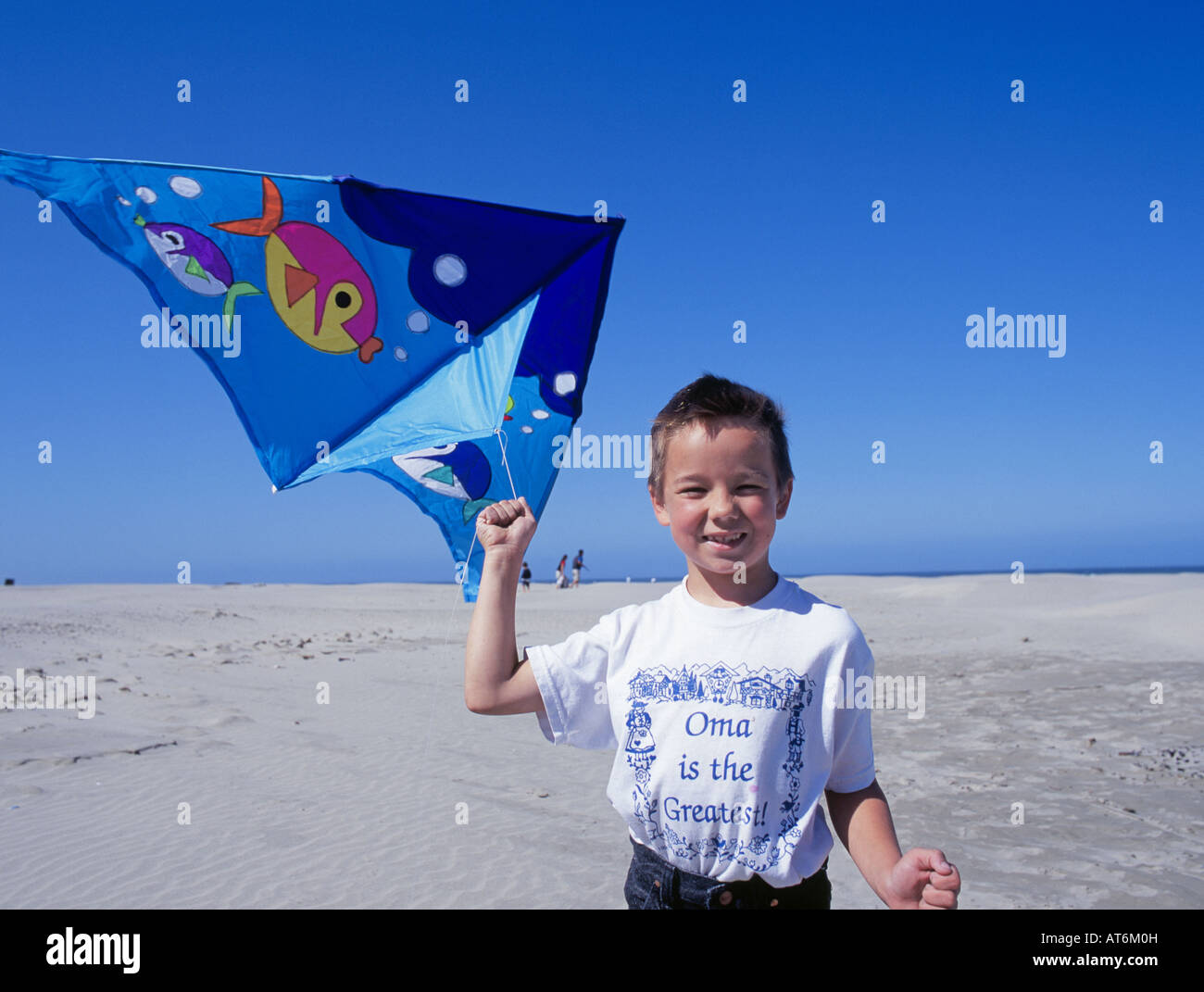 A young boy flies a kite on the beach in Newport Oregon Stock Photo Alamy