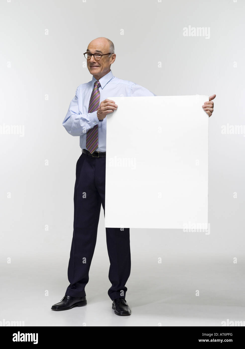 Businessman holding cardboard, portrait Stock Photo