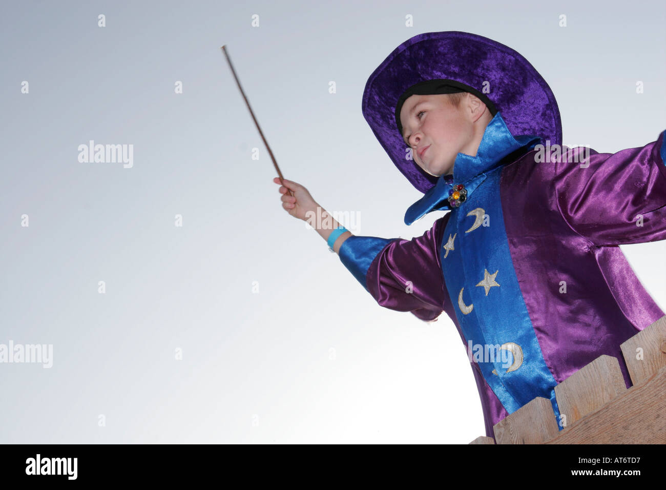 Boy in a wizard costume with magic wand Stock Photo