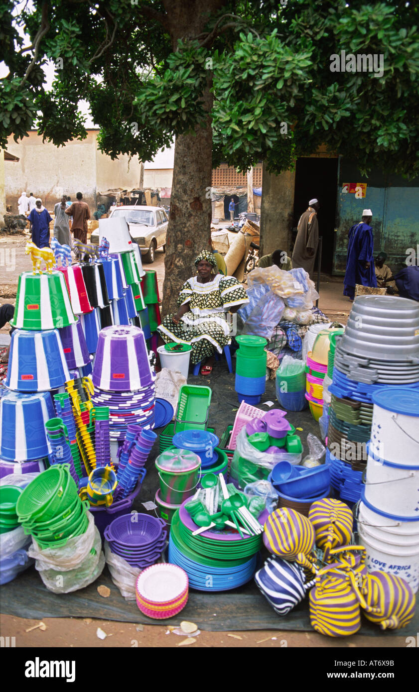 Malian woman sitting at her roadside stall selling cheap plastic kitchenware and utensils, next to the main market in Mopti, Mali Stock Photo