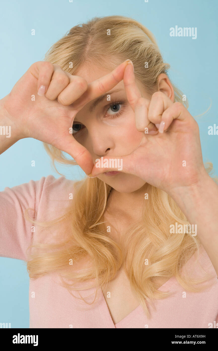 Blonde woman making hand gesture, portrait Stock Photo