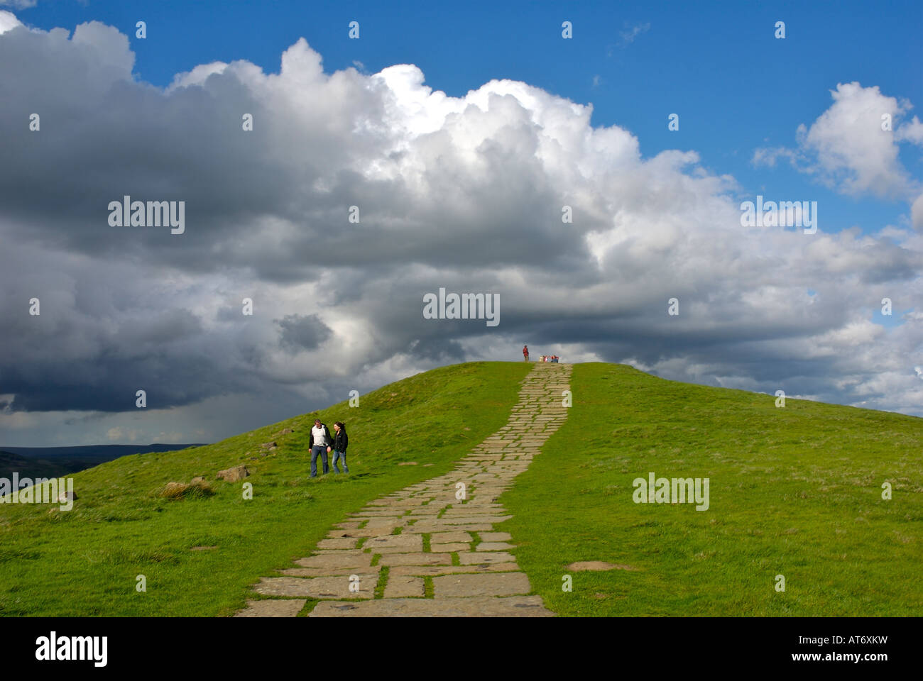 Walkers and paved path, leading to the top of Mam Tor, overlooking the Edale valley, Peak National Park, Derbyshire UK Stock Photo