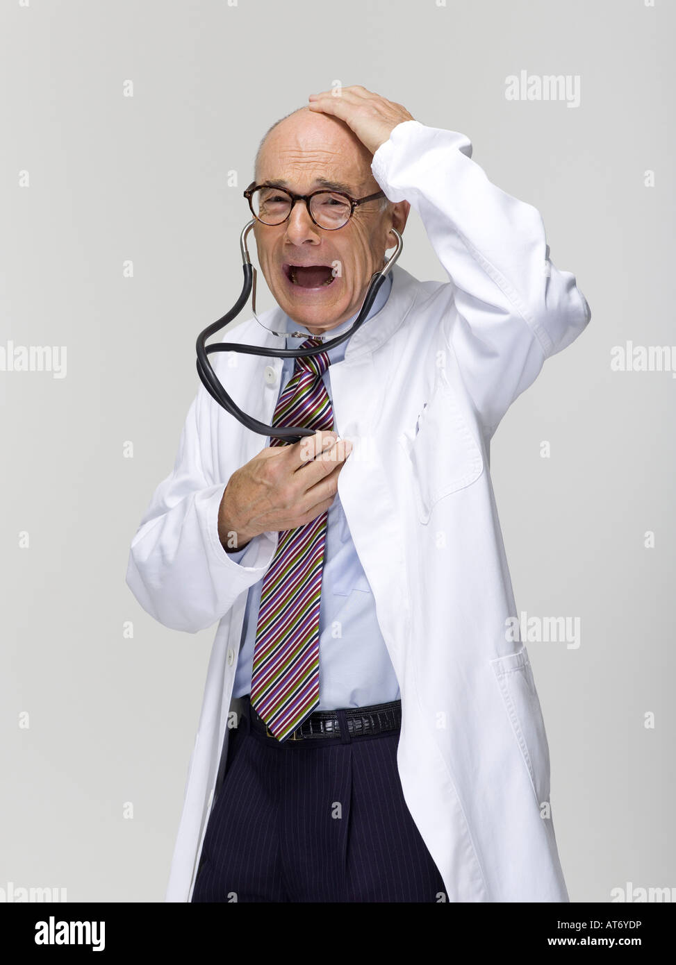 Portrait of a senior male doctor, holding stethoscope Stock Photo - Alamy