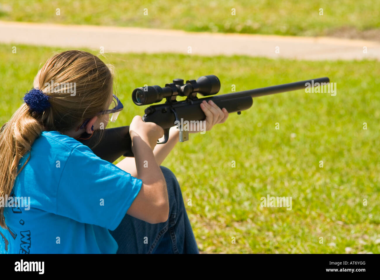 Girl shooting at 4-h event field and stream shooting sports Stock Photo