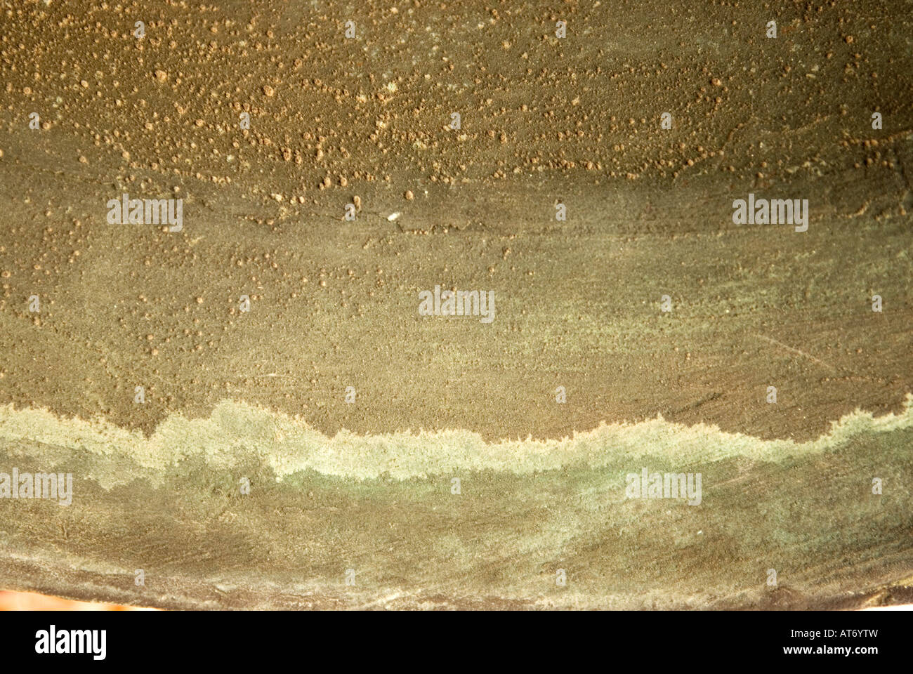 Bronze texture in the interior of a bell with dent made by the hit of ...