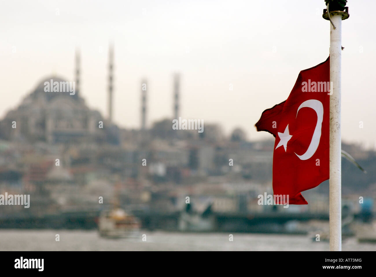 The Turkish flag seen against part of the Istanbul skyline. Stock Photo
