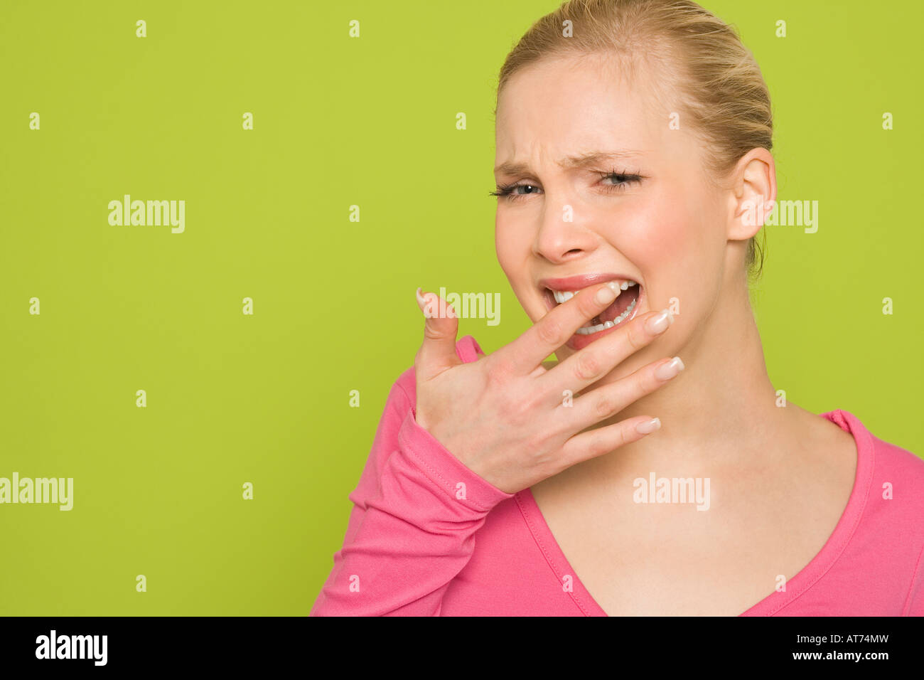 Woman feeling her tooth with her finger, portrait Stock Photo Alamy