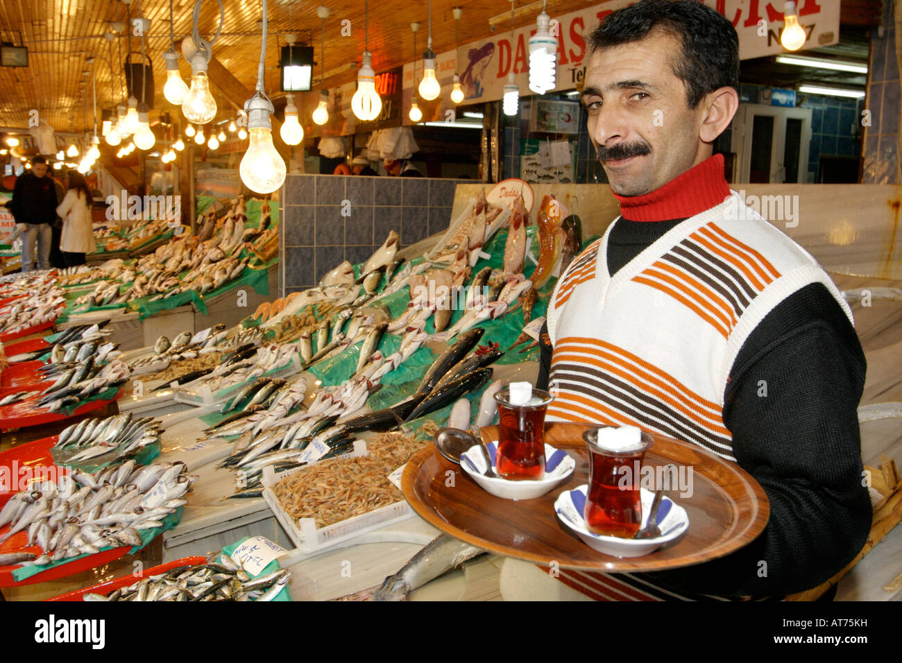 Traditional Turkish tea vendor in the Kumkapi fish market in Istanbul, Turkey. Stock Photo