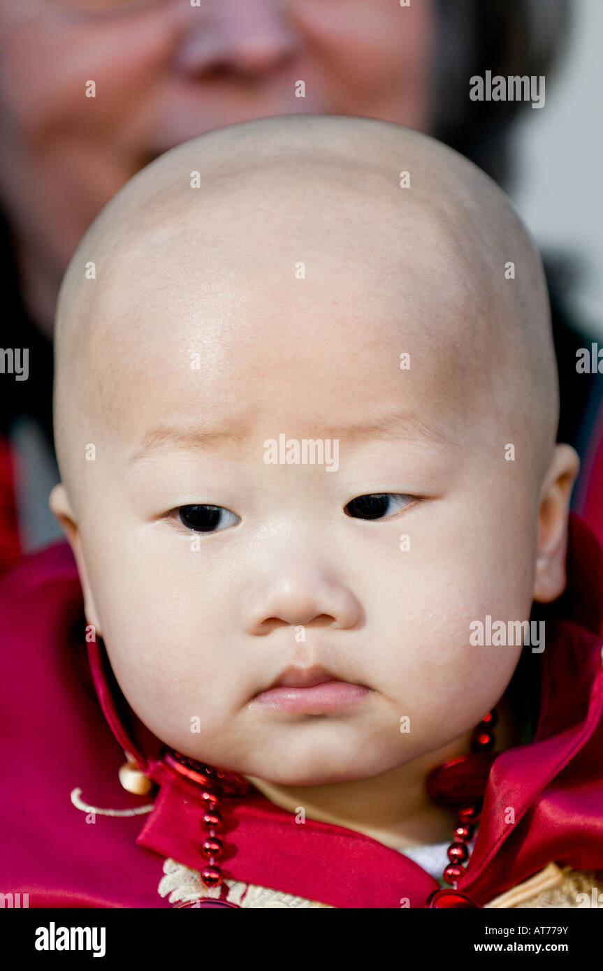 Chinese baby with bald head in costume for Chinese New Year Stock Photo Alamy