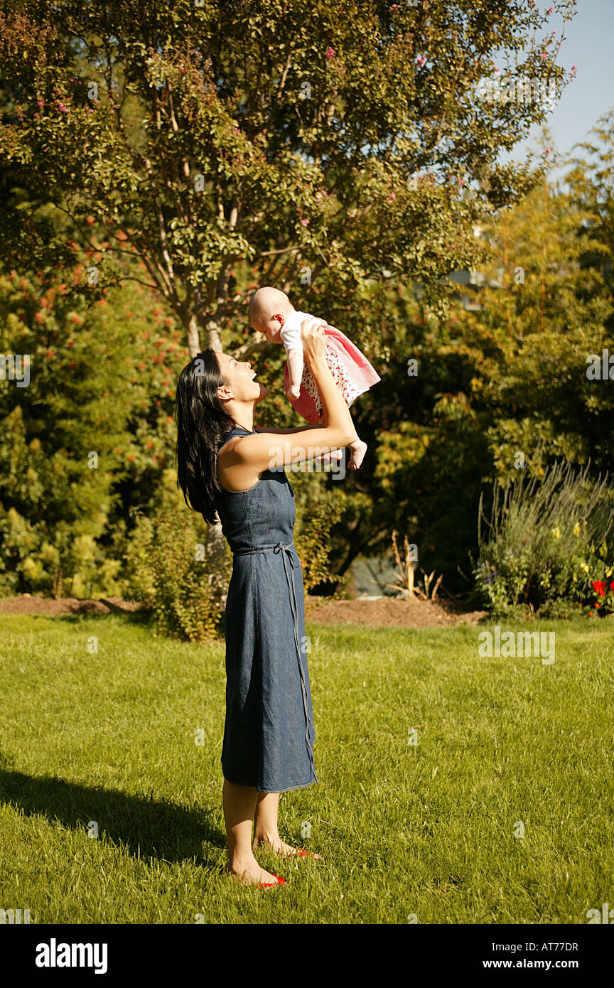Woman holding up baby hi-res stock photography and images - Alamy