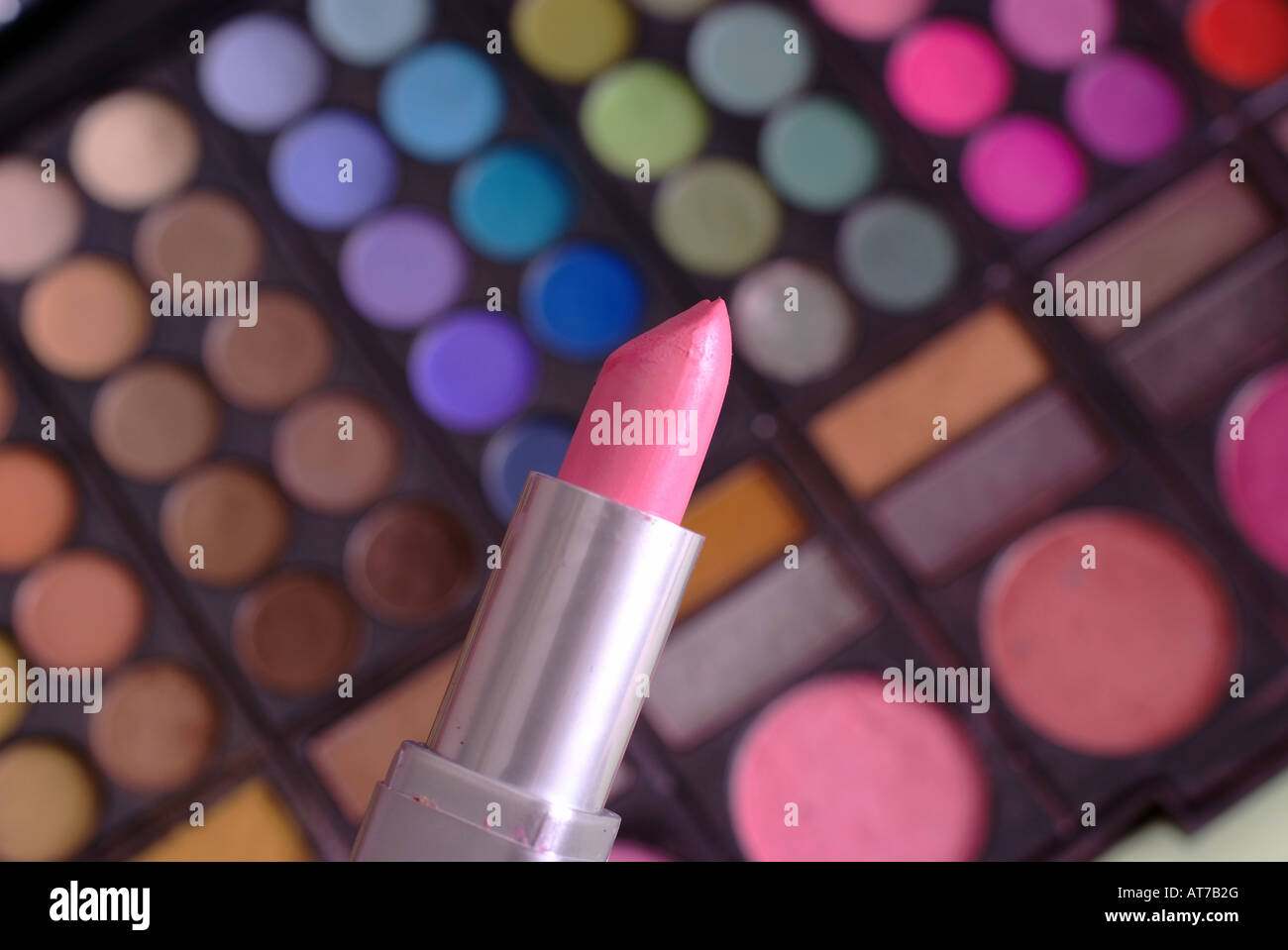 a single lipstick in front of colors Stock Photo
