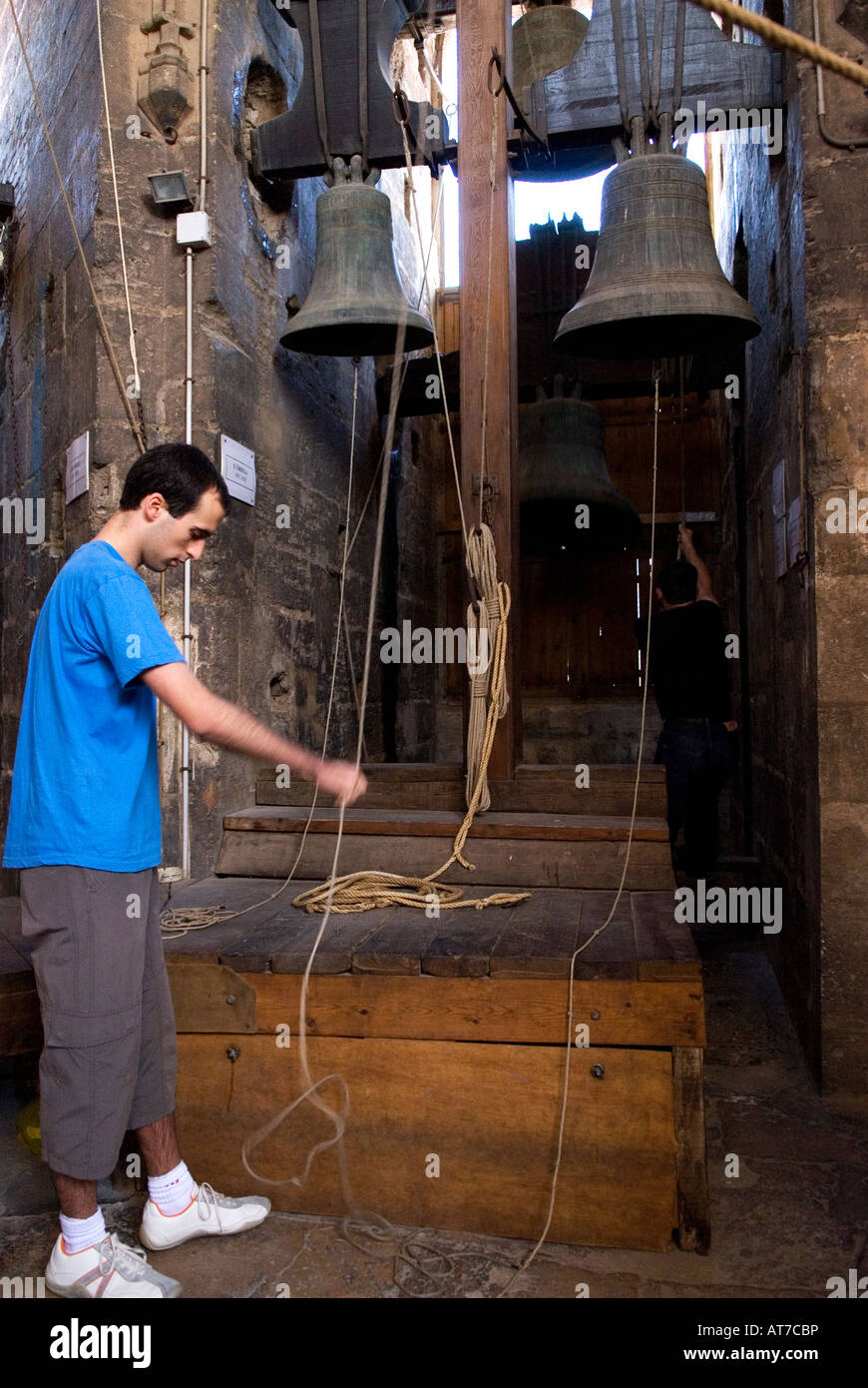 Bell ringer playing  in the tower bell known as the Torre del Miguelete next to the cathedral of Valencia, Spain Stock Photo