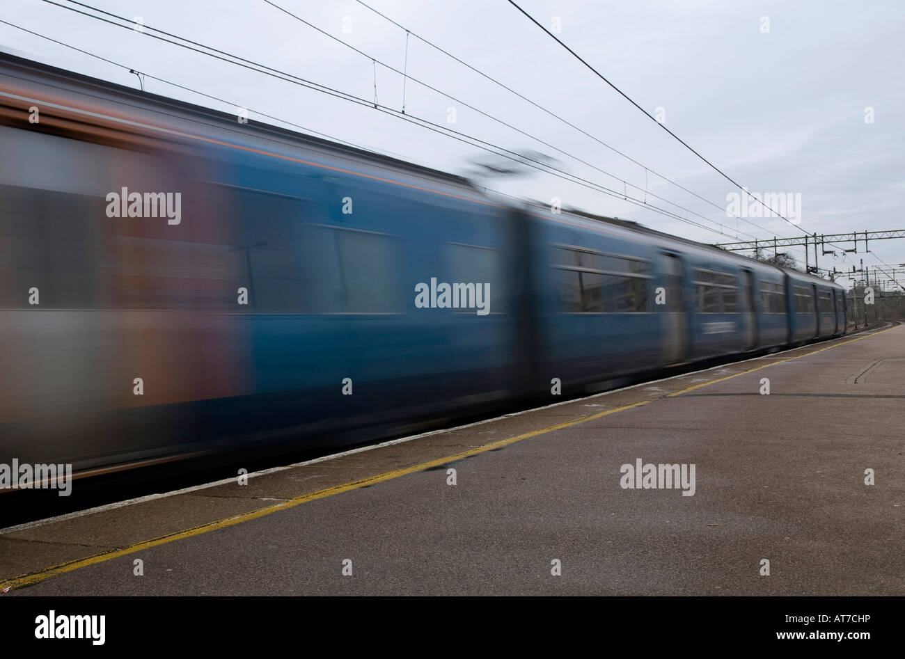 The Stansted Express train speeds through Harlow Town Railway Station