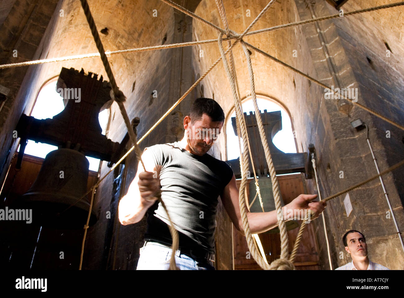 Bell ringer playing  in the tower bell known as the Torre del Miguelete next to the cathedral of Valencia, Spain Stock Photo