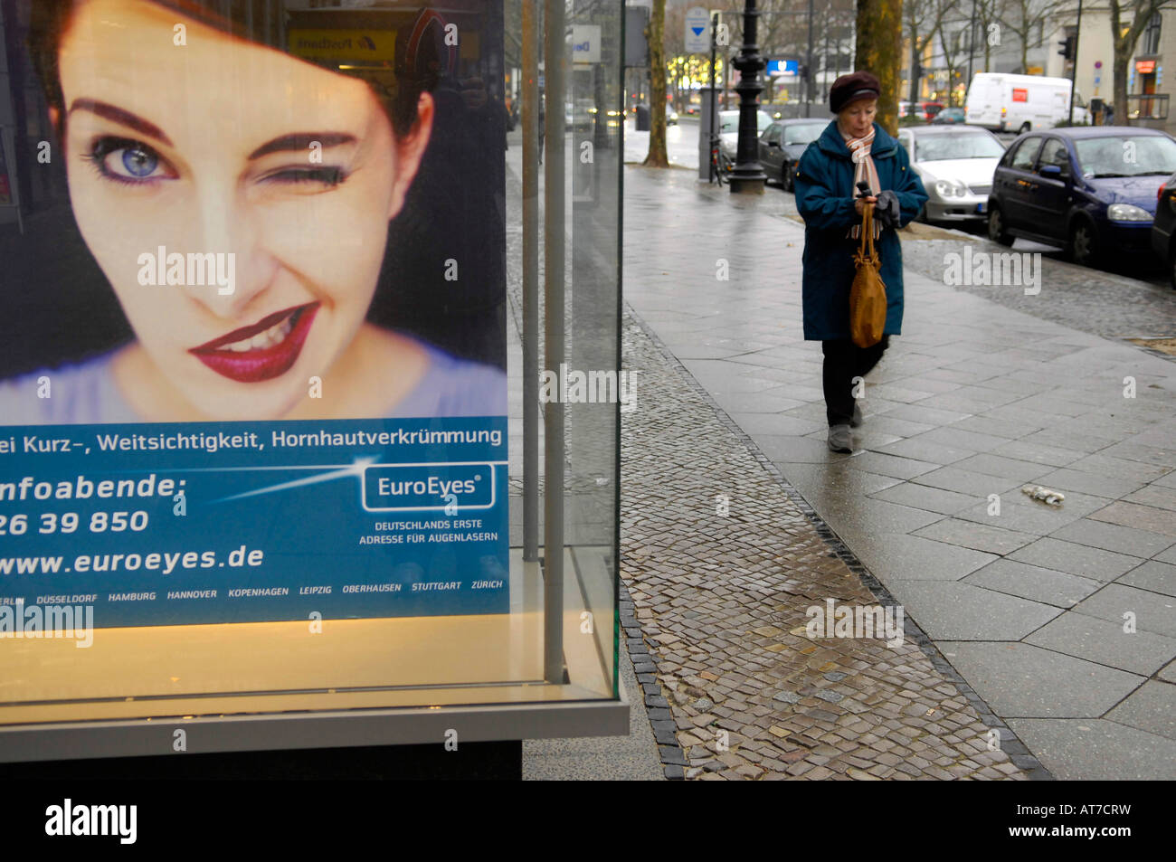 advertising display woman wink pedestrian old lady city ku-damm kurfurstendam berlin germany travel tourism Stock Photo