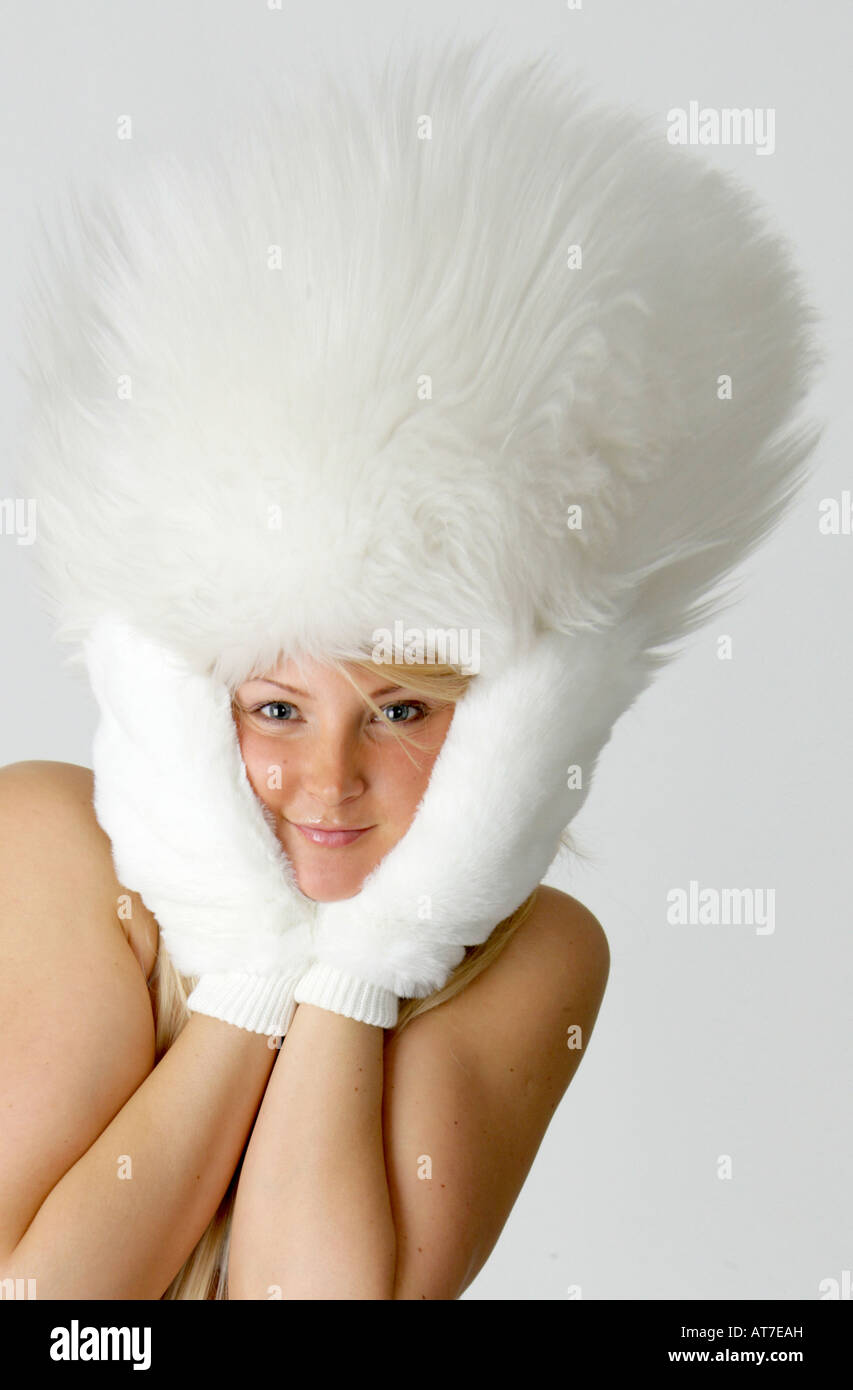 Fantasy Portrait of a Young Blonde Girl in a White Fur Hat - Distorted Image Stock Photo