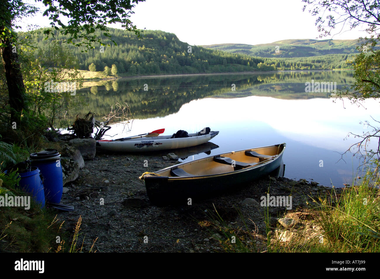 Canoes on beach during camping trip Stock Photo Alamy