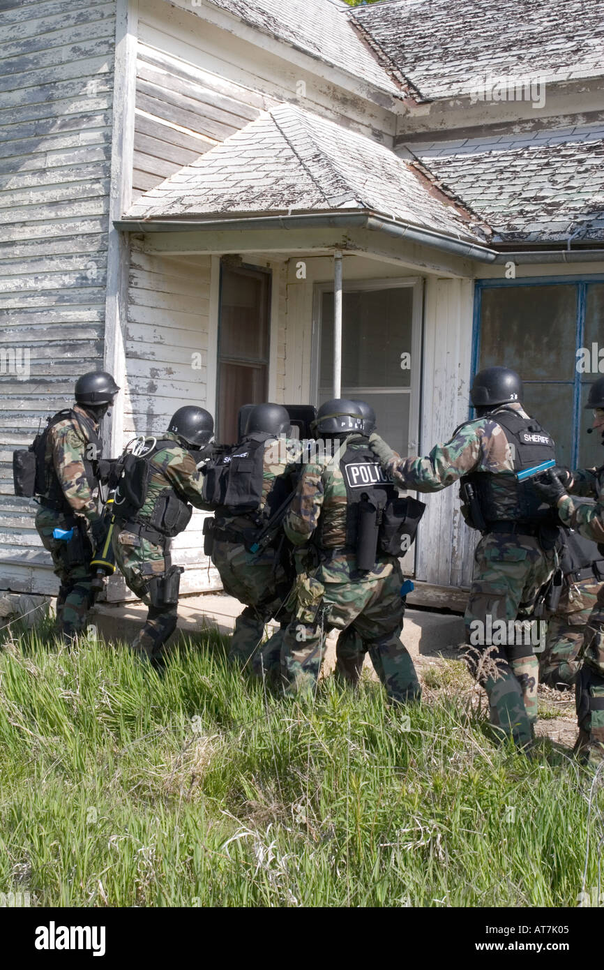 SWAT training. Moving in formation approaching a building. Stock Photo