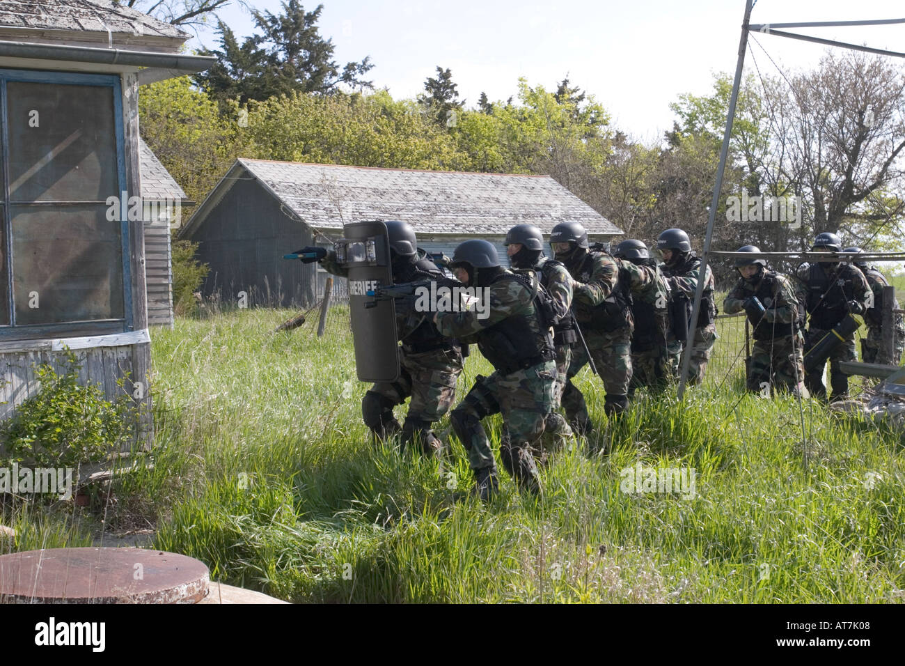 SWAT training. Moving in formation approaching a building. Stock Photo