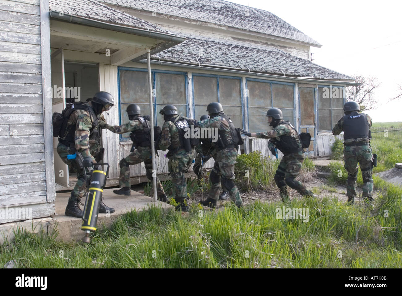 SWAT training. Moving in formation approaching a building. Stock Photo