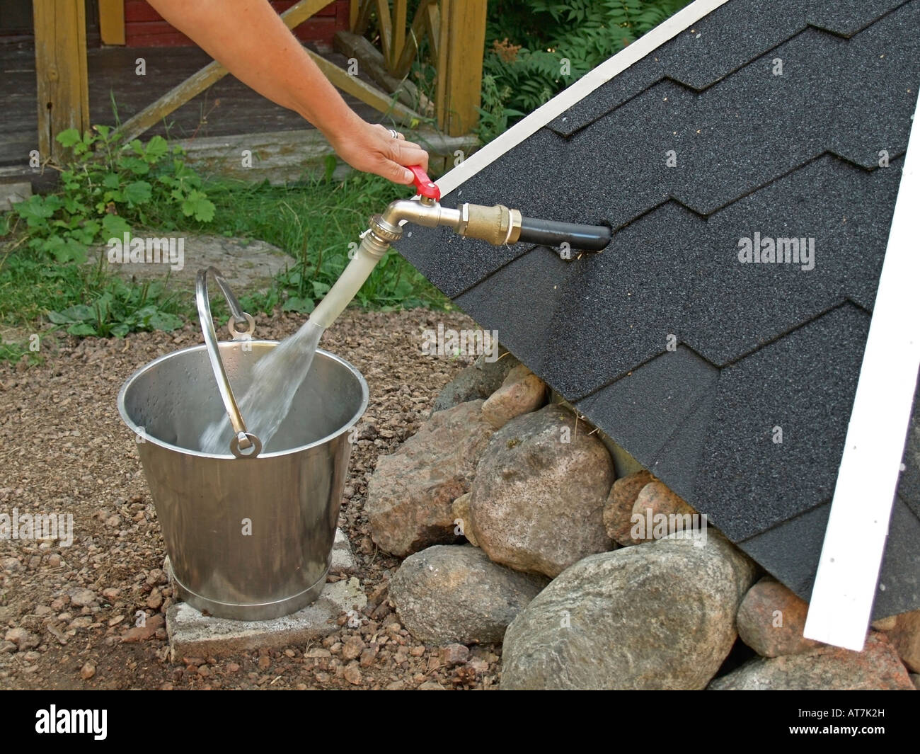 hand tapping drinking water from a well water running from tap into a