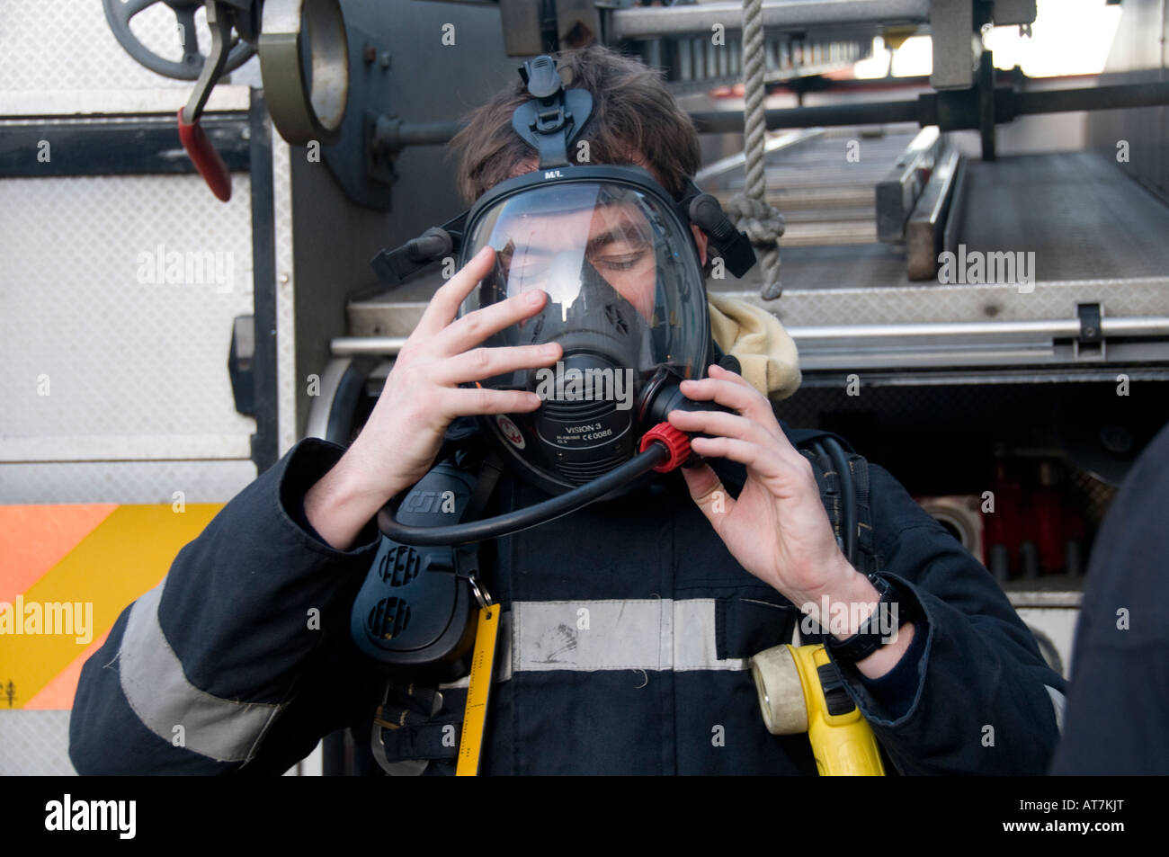 fireman removing his breathing apparatus after dealing with a 999 emergency call out Stock Photo