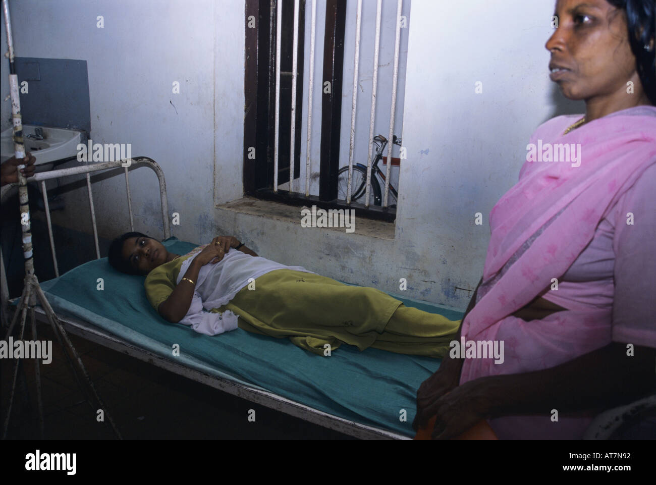 A woman awaiting treatment in an Indian hospital, tamil nadu. Stock Photo