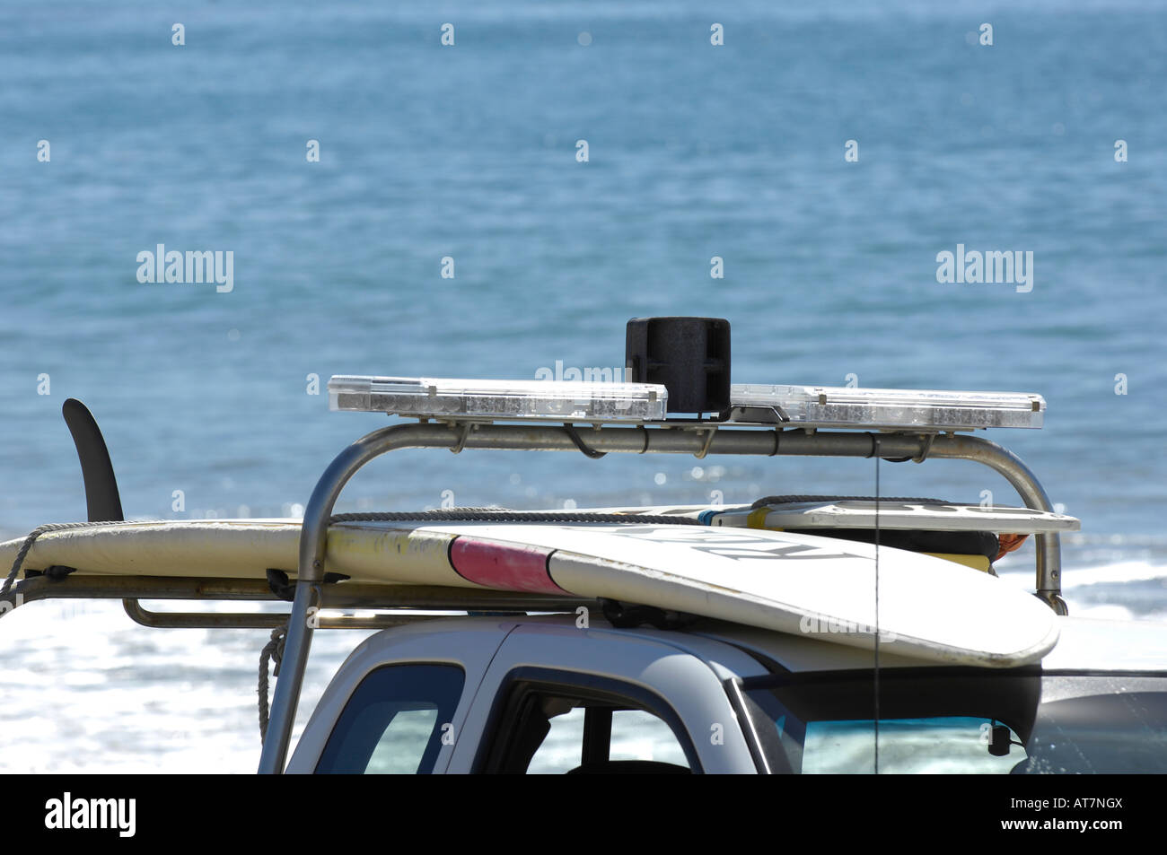 LED lights on an emergency vehicle allow first responders to be highly visible, Lifeguard rescue truck with surf board. Stock Photo