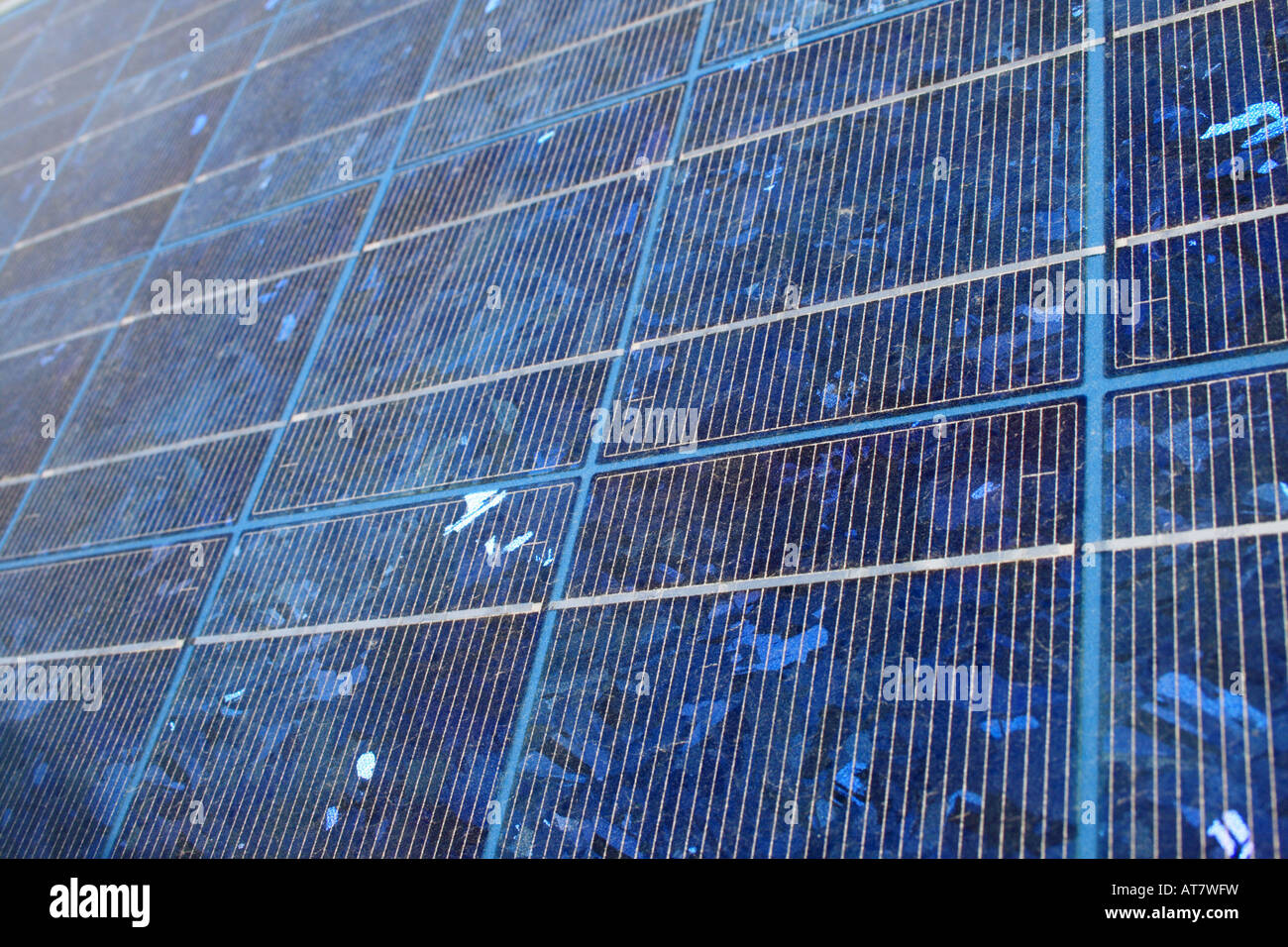 blue tinted polycrystalline silicon photovoltaic solar panel at an angle with shallow depth of field Stock Photo